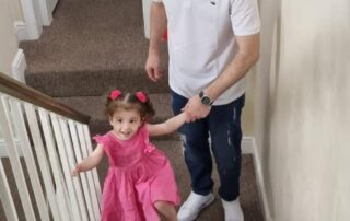 father and daughter climbing stairs