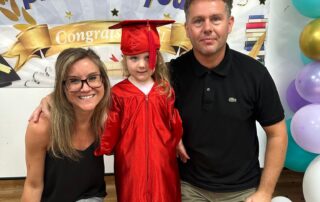 parents and child celebrating graduation day