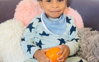 nursery child enjoying halloween pumpkins