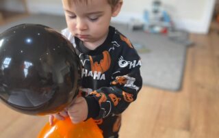 nursery child with halloween balloons