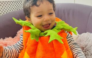 nursery child in pumpkin outfit